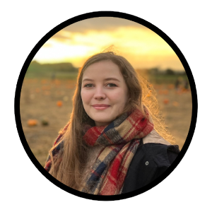 Lydia, a white person with long hair is smiling softly